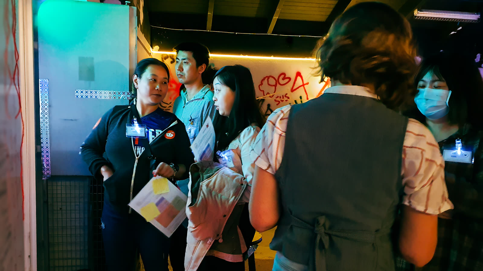 Players arriving at the venue entry with character documents in hand