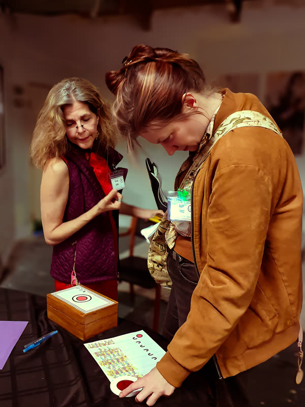 Two players across age ranges collaborating on a puzzle