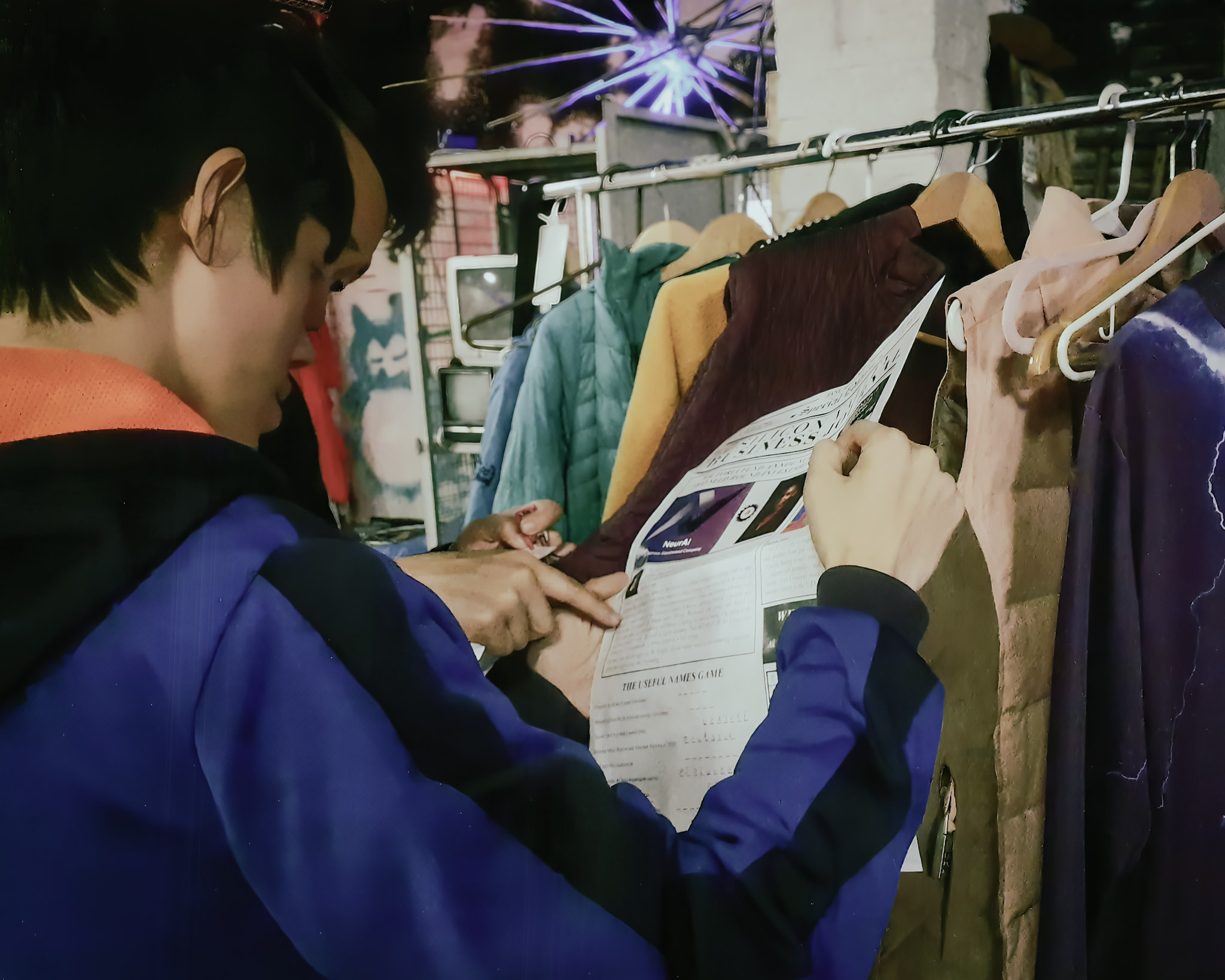 The players discover a newspaper in one of the characters' purse found in the coat-check area of the party.